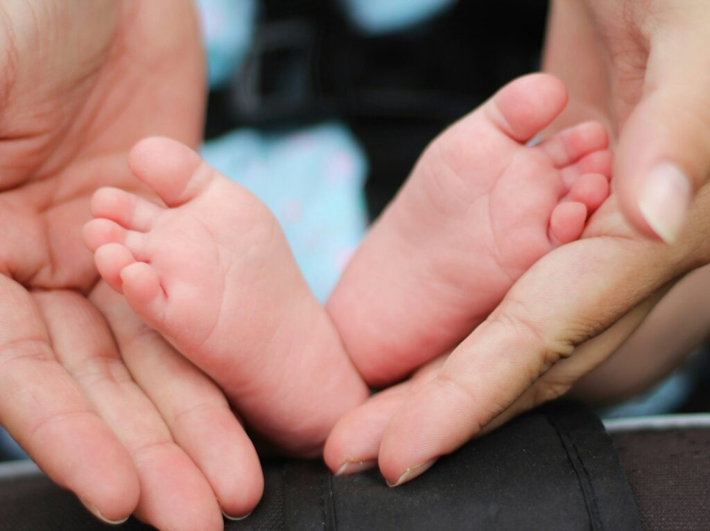 Life Assurance Tips 4 person holding baby feet