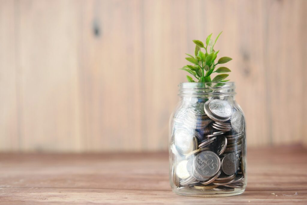 Retirement Planning 1 a glass jar filled with coins and a plant