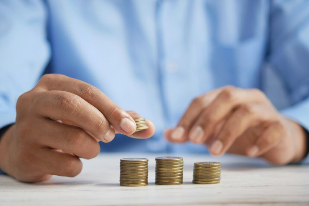 Tips for Investing 12 a person stacking coins on top of a table