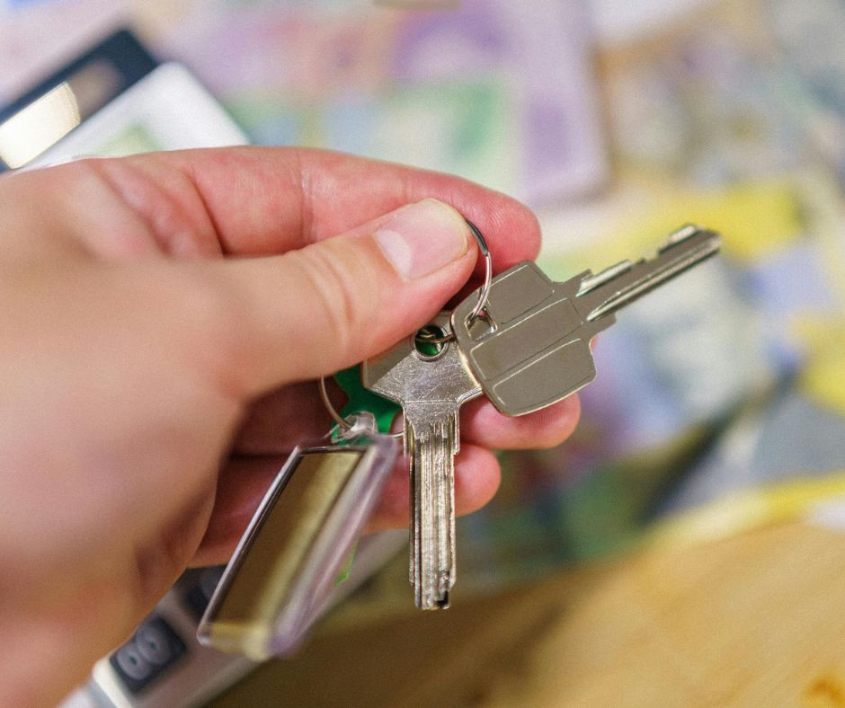 A hand holding a set of keys