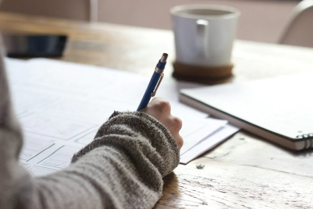 Inheritance Tax Planning 3 person writing on brown wooden table near white ceramic mug