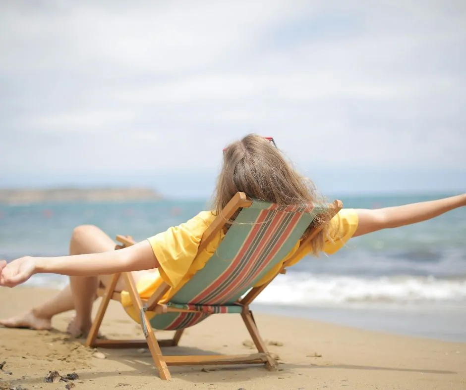 Investment Management in Cheshire 20 A woman sat in a deckchair on the beach